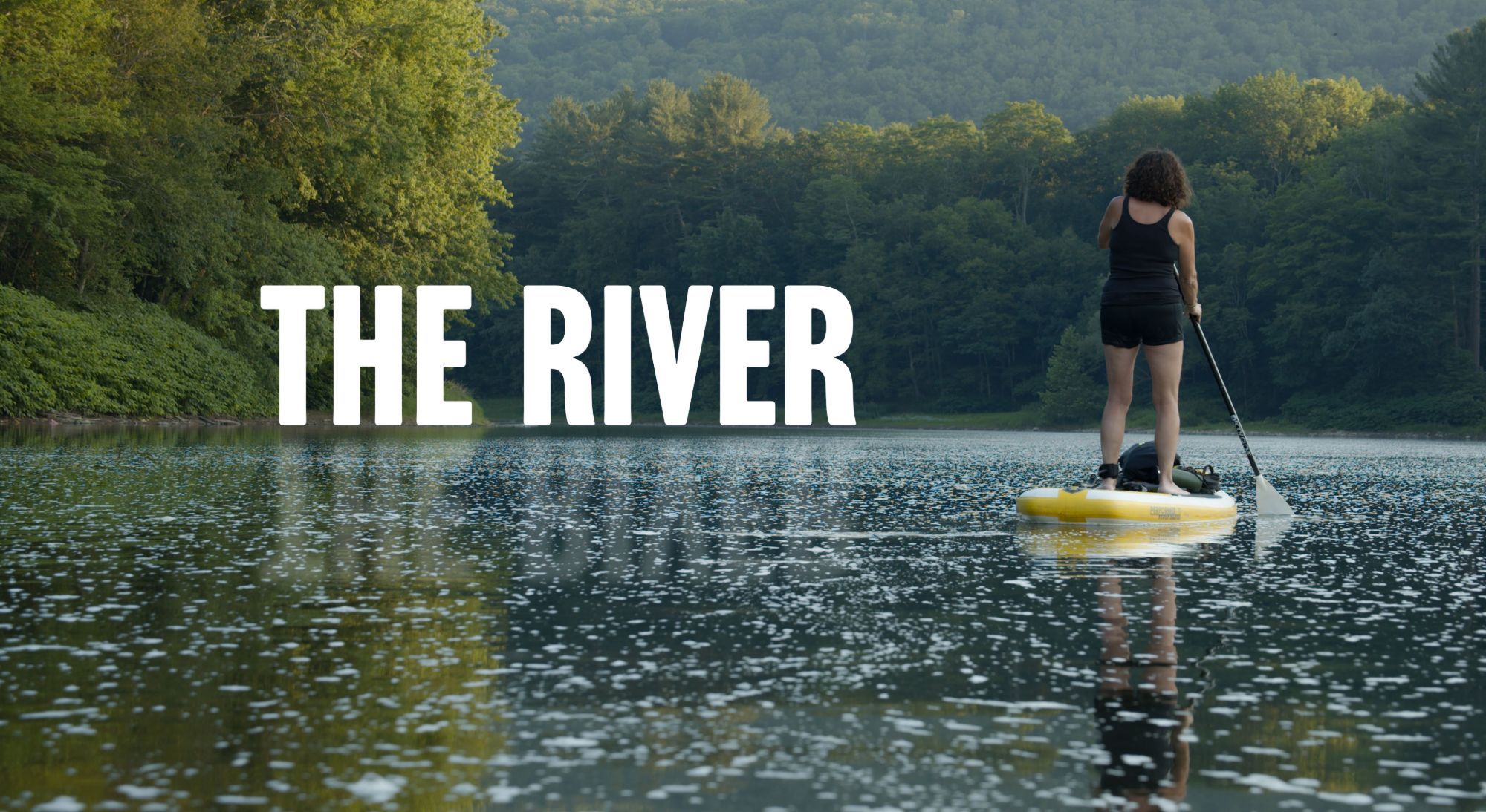 The River film poster — a paddleboarder on the river outside Hancock, New York